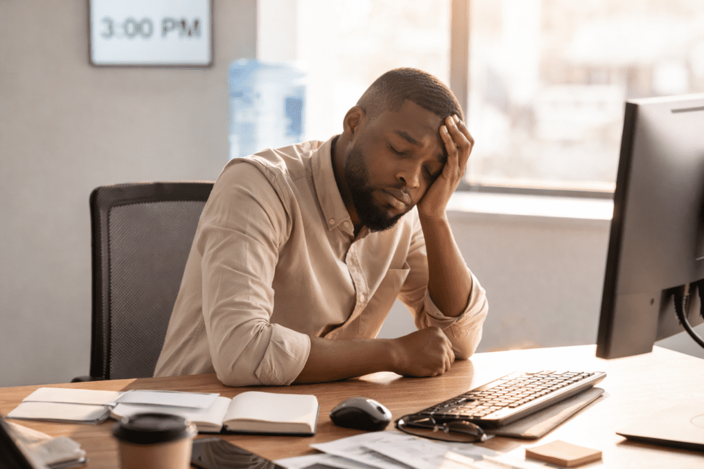 Office worker experiencing afternoon blood sugar crash symptoms